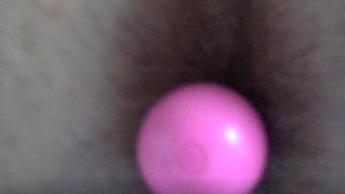 zoom on a small pink vibrator which I put in a hole in the ass